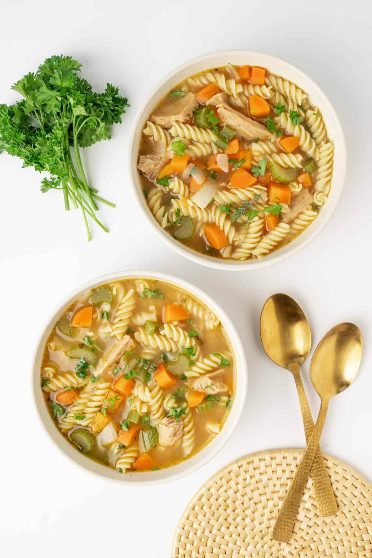 Two bowls of vegan chicken noodle soup.