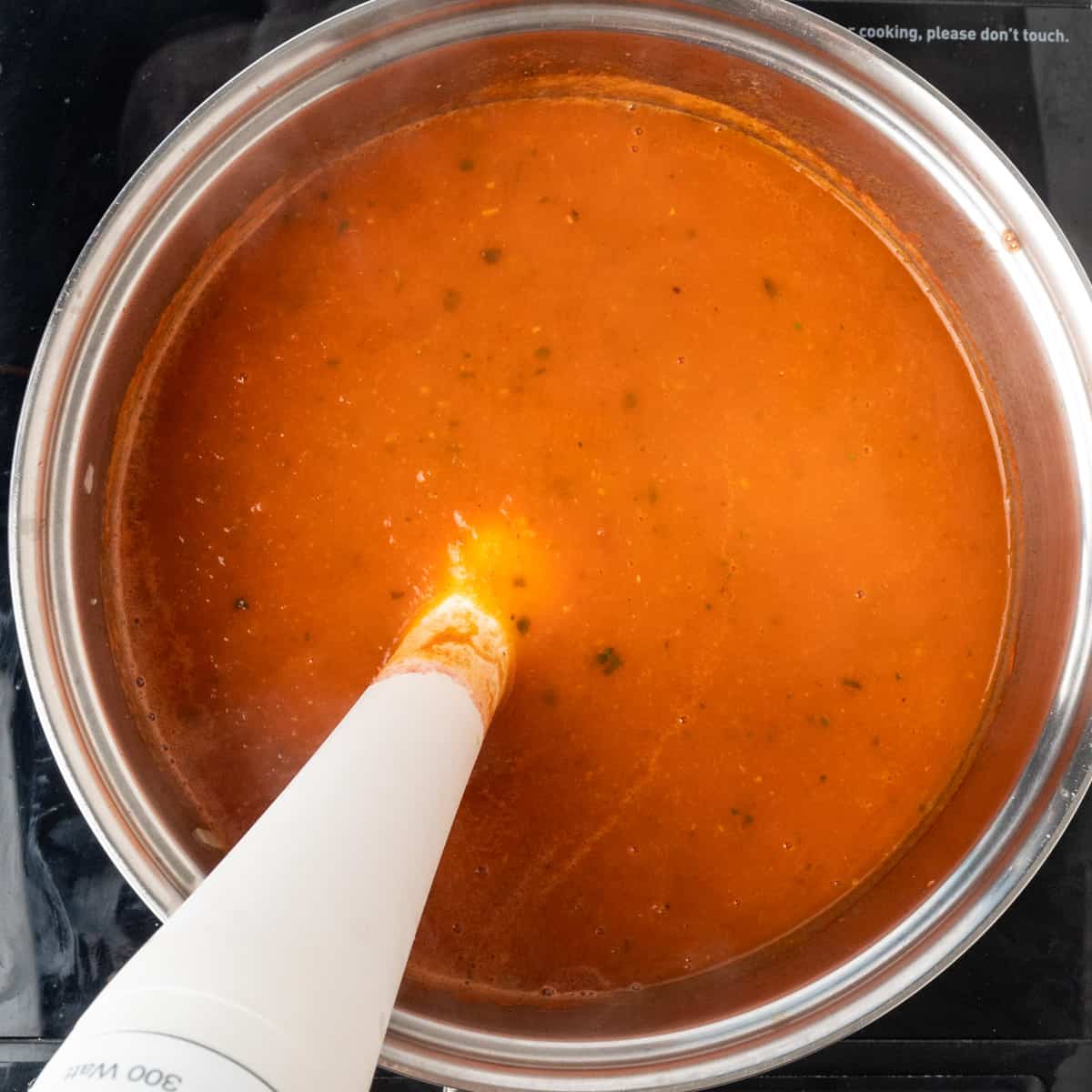 Pureeing soup with an immersion blender.