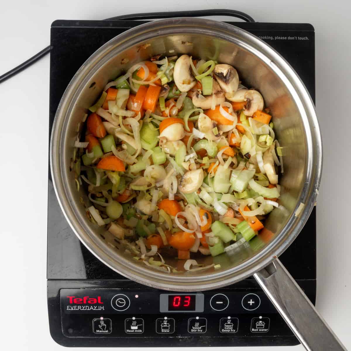 Sauteing vegetables in a sauce pan.